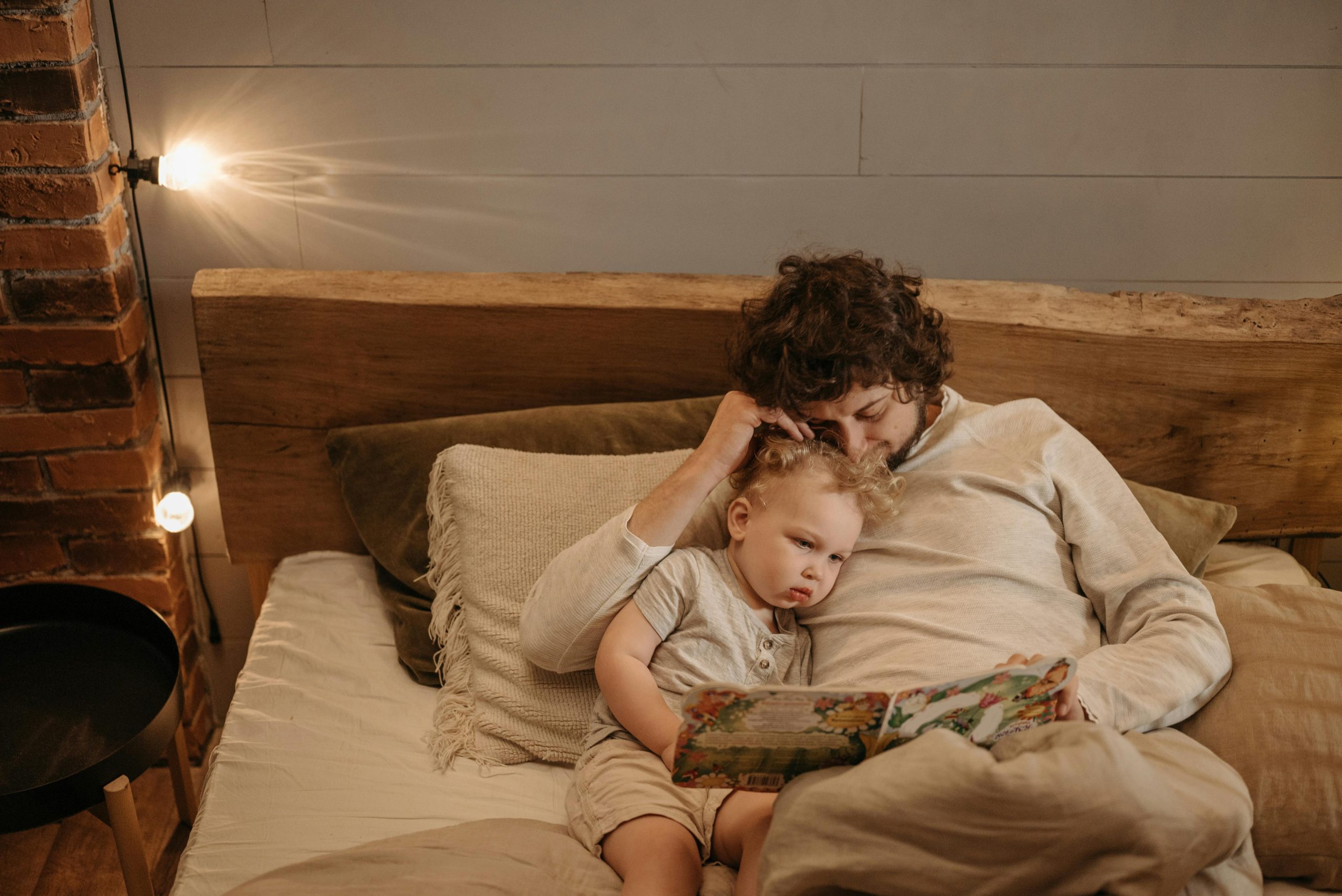 dad reading to this child in bed dad reading to this child in bed