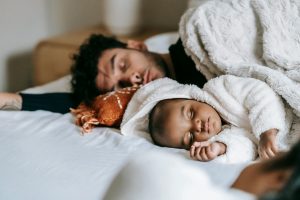 baby sleeping next to day